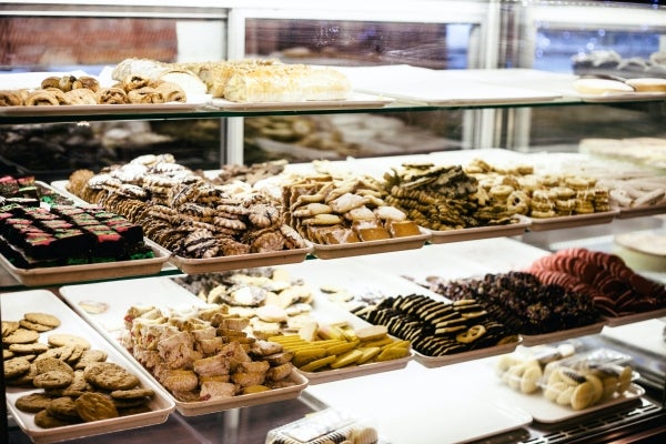 Variety of cookies displayed in glass case in a bakery