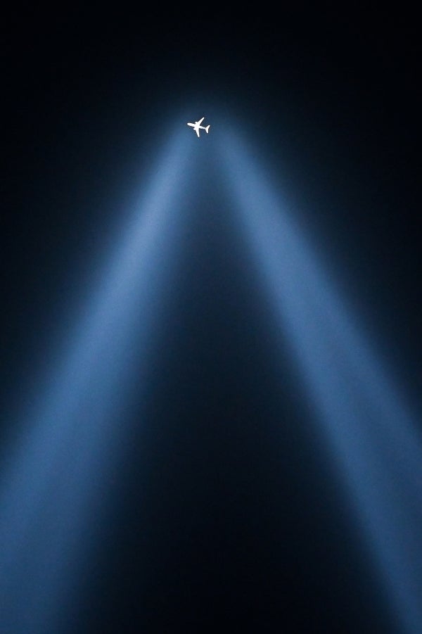 A plane flies over the Tribute in Light on the 20th anniversary of 9/11 in New York City, N.Y. on Sept. 11, 2021.