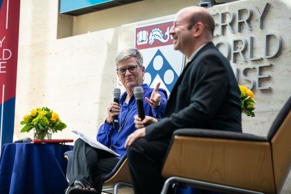 Kathleen Hall Jamieson gestures at Michael E. Mann on the Perry World House stage