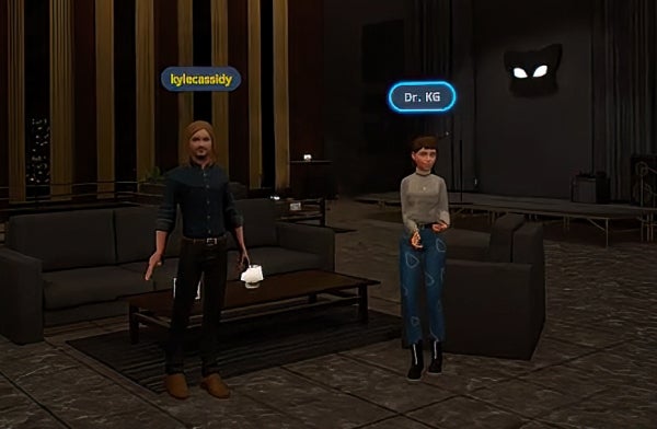 Two avatars in a virtual room standing in front of a couch