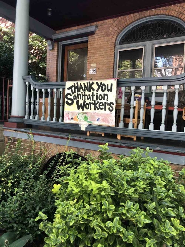 West Philly porch with a homemade sign reading "Thank You Sanitation Workers"