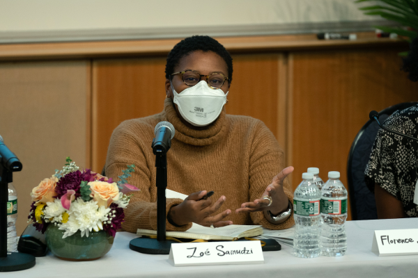 Zoé Samudzi sits at a table