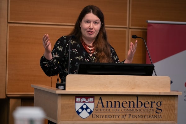 Olena Lysenko speaks at a podium