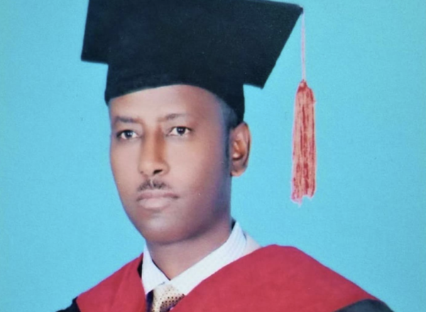 A portrait of Maereg Amare in academic regalia