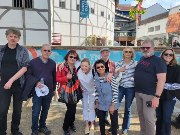 A group of people in front of the Globe Theater