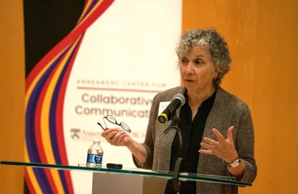 Paula Span speaking at a podium