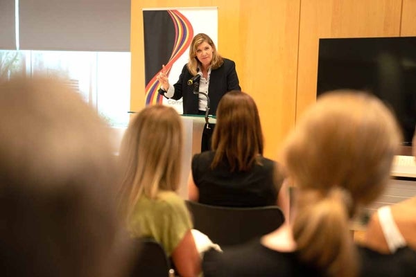 Sarah Banet-Weiser speaking at a podium with audience heads visible