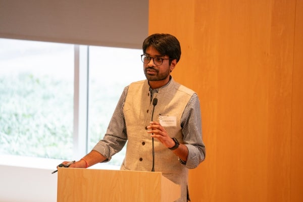 Sandeep Mertia speaks at a podium