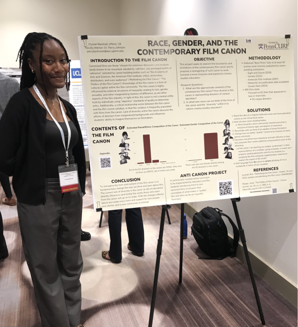 Crystal Marshall stands next to a research poster