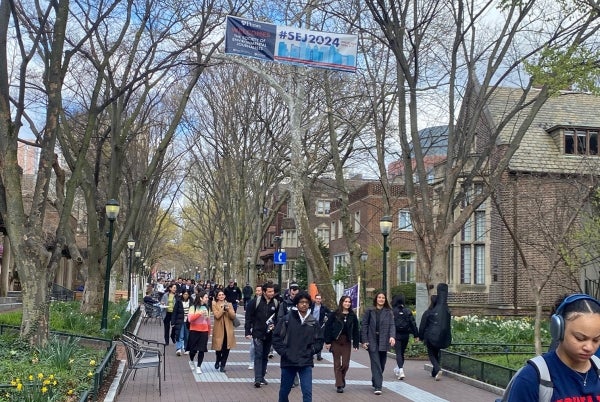 A banner advertising #SEJ2024 hangs over Penn’s Locust Walk.