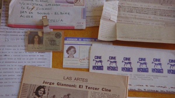 A photograph of documents, notes, and IDs assembled on a table