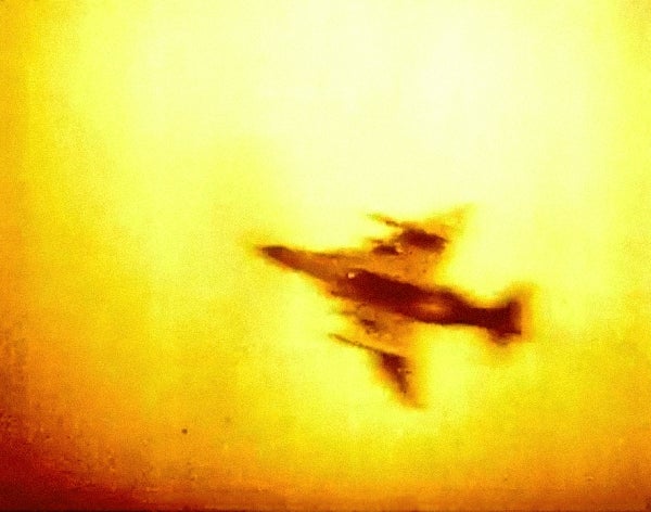Image of an airplane in an orange-colored sky