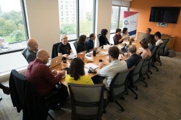 CARGC members sitting in a conference room during a meeting