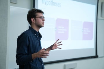 Photo of Joyner presenting his final project in COMM 310: Communication Research Experience