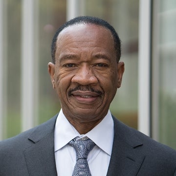 Headshot of John B. Jemmott III in a suit and tie