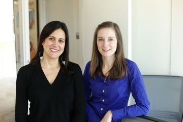 Amy Bleakley and Morgan Ellithorpe posing in black and royal blue shirts respectively