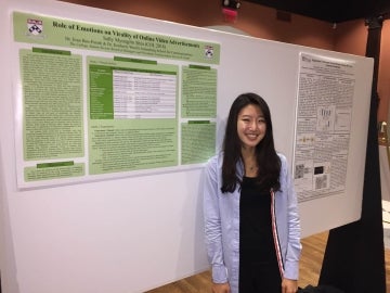 Sally Shin poses in front of her research project