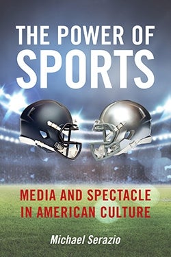 Cover of Michael Serazio's ' The Power of Sports: Media and Spectacle in American Culture'. The background is a football field, and in the forefront are two football helmets, black and silver, facing each other. Above the helmets is the title in white font, below the helmets is the subtitle in red font. Both are written in upper case. Below the subtitle is the author's name in white.