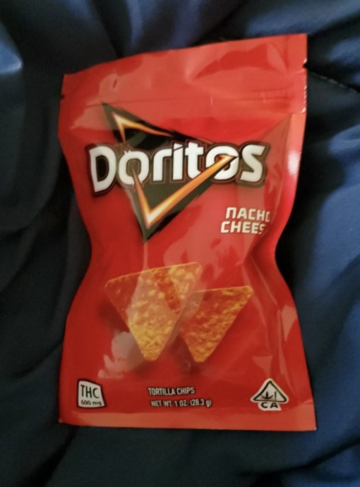 Bag of nacho cheese Doritos that looks identical to real Doritos, but it has a THC label on the bottom corner