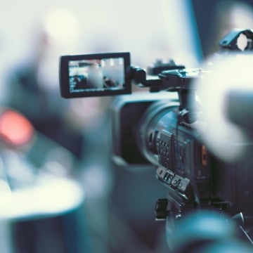Behind shot of camera filming