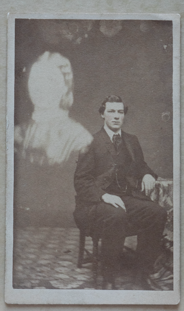A spirit photograph shows a man and a blurry spirit